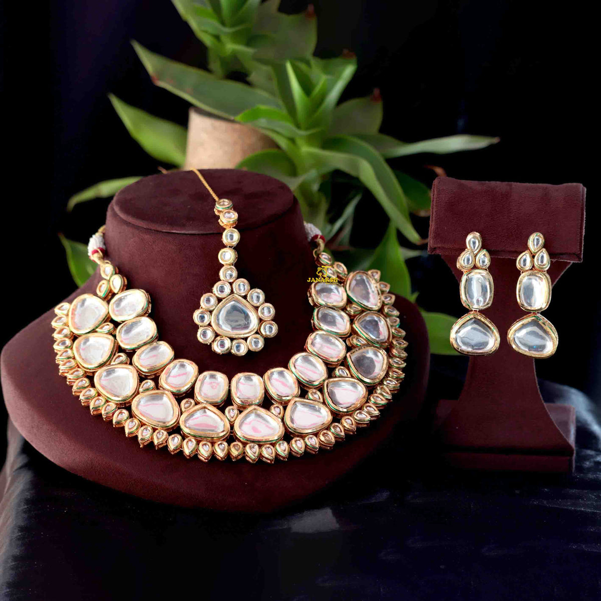 Kundan-style necklace set with matching earrings and maang tikka displayed together