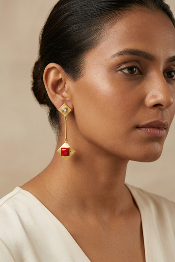 Model preview wearing the red geometric brass earrings